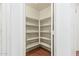 A walk-in pantry with wood-look flooring and white shelving at 8939 W Villa Rita Dr, Peoria, AZ 85382