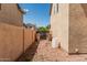 A clean, functional side yard with a gate and storage for trash cans at 8939 W Villa Rita Dr, Peoria, AZ 85382