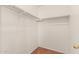 Walk-in closet with wood-look floors and built-in metal hanging rods at 8939 W Villa Rita Dr, Peoria, AZ 85382