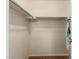 Bright walk-in closet with wood-look floors, white walls, and built-in metal hanging rods at 8939 W Villa Rita Dr, Peoria, AZ 85382