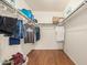 Bright walk-in closet with ample storage space featuring wood-look flooring and metal racks at 8939 W Villa Rita Dr, Peoria, AZ 85382