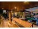 Beautiful backyard pool area with covered outdoor kitchen, poolside seating, and lush landscaping for privacy at 9255 W Los Gatos Dr, Peoria, AZ 85383