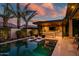 Stunning backyard pool with lush landscaping, outdoor kitchen, and comfortable lounge chairs perfect for relaxation at 9255 W Los Gatos Dr, Peoria, AZ 85383