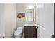 Modern powder room featuring a sleek vanity, stylish mirror, and a comfort-height toilet at 9255 W Los Gatos Dr, Peoria, AZ 85383