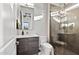 Well-lit bathroom featuring a glass-enclosed shower, sleek vanity, and modern toilet at 9255 W Los Gatos Dr, Peoria, AZ 85383