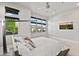 Bright bedroom with large windows, a ceiling fan, view of the backyard, and a contemporary TV at 9255 W Los Gatos Dr, Peoria, AZ 85383