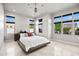 Bright bedroom with large windows, tile floors, and minimalist decor for a serene space at 9255 W Los Gatos Dr, Peoria, AZ 85383