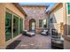 Private courtyard with stone fireplace, comfortable seating, and a wrought iron gate at 9255 W Los Gatos Dr, Peoria, AZ 85383