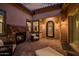 Cozy courtyard with stone fireplace, outdoor seating, and a charming arched doorway at 9255 W Los Gatos Dr, Peoria, AZ 85383