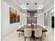 Dining room featuring a large table, modern chandelier, and colorful artwork, perfect for gatherings at 9255 W Los Gatos Dr, Peoria, AZ 85383