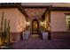 Inviting entrance with stone accents, decorative plants, and an ornate iron gate at 9255 W Los Gatos Dr, Peoria, AZ 85383