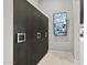 Hallway with sleek, dark wood accents and modern door hardware leading to other areas of the home at 9255 W Los Gatos Dr, Peoria, AZ 85383