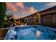 Luxurious hot tub in a beautifully landscaped backyard, with a pool, outdoor kitchen, and inviting fire pit nearby at 9255 W Los Gatos Dr, Peoria, AZ 85383