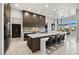 Modern kitchen features an expansive island, sleek dark cabinetry, and stainless steel appliances at 9255 W Los Gatos Dr, Peoria, AZ 85383