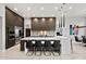 Stylish kitchen featuring a breakfast bar, modern appliances, and sleek cabinetry at 9255 W Los Gatos Dr, Peoria, AZ 85383