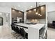 Modern kitchen with a large island, high-end appliances, sleek cabinetry, and counter seating at 9255 W Los Gatos Dr, Peoria, AZ 85383