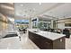 Open kitchen with a large island, stone countertops, sleek dark cabinetry, and views of the dining and living areas at 9255 W Los Gatos Dr, Peoria, AZ 85383