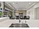 Open-concept living room with a fireplace, modern decor, a large window, and outside view at 9255 W Los Gatos Dr, Peoria, AZ 85383