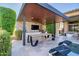 Inviting outdoor kitchen features a built-in grill, modern countertops, and a covered dining area with TV at 9255 W Los Gatos Dr, Peoria, AZ 85383