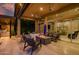 Relaxing outdoor living area with comfortable seating, a modern fire pit, and seamless access to the indoor living space at 9255 W Los Gatos Dr, Peoria, AZ 85383