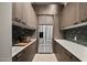 Walk-in pantry with custom wood cabinets, stainless steel fridge, and ample countertop space at 9255 W Los Gatos Dr, Peoria, AZ 85383
