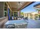 Covered patio offers an outdoor seating area, a tub and a view of the sparkling pool and landscape at 9255 W Los Gatos Dr, Peoria, AZ 85383