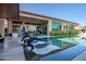 Inviting pool with submerged loungers, set in a private backyard with lush landscaping and patio area at 9255 W Los Gatos Dr, Peoria, AZ 85383