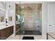 Modern bathroom with a glass-enclosed shower featuring multiple shower heads and sleek tile work at 9255 W Los Gatos Dr, Peoria, AZ 85383