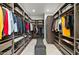 Spacious walk-in closet with custom shelving, hanging racks, and bench seating for organized storage at 9255 W Los Gatos Dr, Peoria, AZ 85383