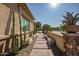 A beautiful walkway leading to the house with desert landscaping and potted plants at 9255 W Los Gatos Dr, Peoria, AZ 85383