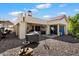Well-maintained backyard with gravel, an umbrella, outdoor cooking area, and covered patio space for entertaining at 10068 E San Salvador Dr, Scottsdale, AZ 85258