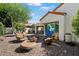 Cozy backyard seating area with gravel landscaping, comfortable chairs, and a fire pit for outdoor enjoyment at 10068 E San Salvador Dr, Scottsdale, AZ 85258