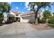 Charming home featuring a red tile roof and a two-car garage with well-maintained landscaping at 10068 E San Salvador Dr, Scottsdale, AZ 85258