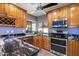 Updated kitchen features custom cabinetry, black granite countertops, and stainless steel appliances at 10068 E San Salvador Dr, Scottsdale, AZ 85258