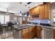 Open kitchen and dining area features granite countertops, stainless steel appliances, and breakfast bar at 10068 E San Salvador Dr, Scottsdale, AZ 85258