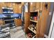 Spacious kitchen includes stainless steel refrigerator and a custom pull-out pantry for organized storage at 10068 E San Salvador Dr, Scottsdale, AZ 85258