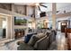 Spacious living room with fireplace, TV and couch offering views of the open layout and high ceilings at 10068 E San Salvador Dr, Scottsdale, AZ 85258