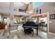 Open living space with high ceilings, wood floors, and a grand piano, perfect for entertaining at 10068 E San Salvador Dr, Scottsdale, AZ 85258