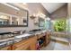 The ensuite main bathroom has a double sink vanity and walk-in shower with a window at 10068 E San Salvador Dr, Scottsdale, AZ 85258