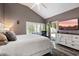 Main bedroom showcases a vaulted ceiling, backyard access, neutral paint, and a light and bright aesthetic at 10068 E San Salvador Dr, Scottsdale, AZ 85258