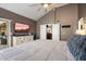This main bedroom has a high ceiling, backyard access, a TV, and a full-length dresser at 10068 E San Salvador Dr, Scottsdale, AZ 85258