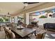 Inviting covered patio with ceiling fans, dining table, and outdoor kitchen setup, perfect for entertaining at 10068 E San Salvador Dr, Scottsdale, AZ 85258