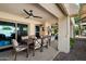 Relaxing covered patio with a ceiling fan, dining area, and access to the home's interior through sliding glass doors at 10068 E San Salvador Dr, Scottsdale, AZ 85258