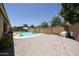 Wide backyard view highlighting a refreshing pool, brick patio, and lush landscaping for outdoor living at 10414 W Windsor Ave, Avondale, AZ 85392