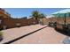 Spacious backyard with brick pavers, complete with a barbecue grill and outdoor dining area under an umbrella at 10414 W Windsor Ave, Avondale, AZ 85392