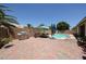 Expansive backyard showcasing a brick-paved patio, barbecue area, and inviting pool for outdoor enjoyment at 10414 W Windsor Ave, Avondale, AZ 85392
