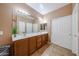 Bathroom featuring double sinks, ample counter space, and a large mirror at 10414 W Windsor Ave, Avondale, AZ 85392