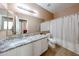 Well-lit bathroom with a granite countertop, and a shower-tub combo at 10414 W Windsor Ave, Avondale, AZ 85392