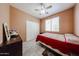 Cozy bedroom with a ceiling fan, closet, and natural light from the window at 10414 W Windsor Ave, Avondale, AZ 85392