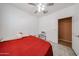 Bright bedroom with a ceiling fan, tile flooring, and natural light from the window at 10414 W Windsor Ave, Avondale, AZ 85392